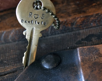 May include: A gold key necklace with a heart and the initials "ROS" and the date "04.11.15" engraved on the key.