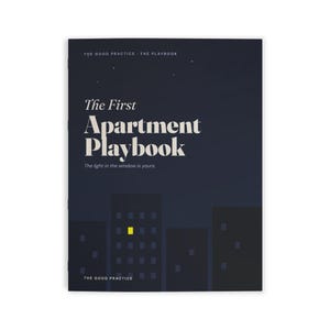 May include: A dark blue book cover titled The First Apartment Playbook with the subtitle The light in the window is yours. The cover features a graphic illustration of city buildings at night with one single window illuminated in bright yellow.