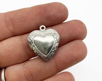 2 Stainless Steel Heart Lockets With Decorative Patterns On The Front D19