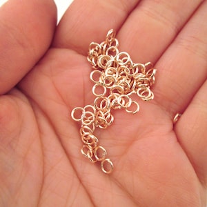 May include: A pile of small gold jump rings, perfect for jewelry making.