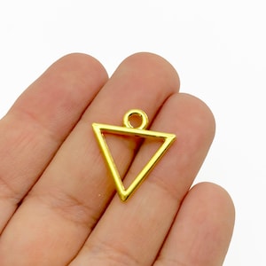 May include: Gold triangle pendant charm with a loop at the top for attaching to jewelry or other crafts.