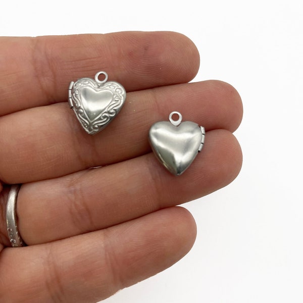 2 Small Stainless Steel Heart Lockets With Decorative Patterns On The Front L157