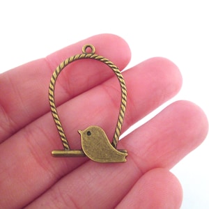 Antique brass bird on a perch charms, bronze pendants, pick your amount, D220