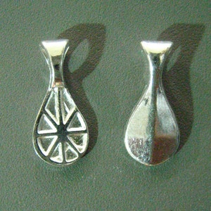 May include: Two silver-toned metal pendant bails with a teardrop shape. One bail has a decorative design of a circle with radiating lines.