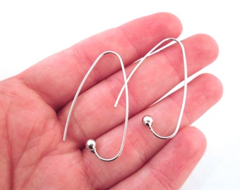 May include: A pair of silver hoop earrings with a small ball at the end of each hoop.