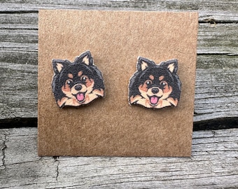 May include: A pair of brown cardboard earring cards with a pair of black and brown dog face earrings on each card.