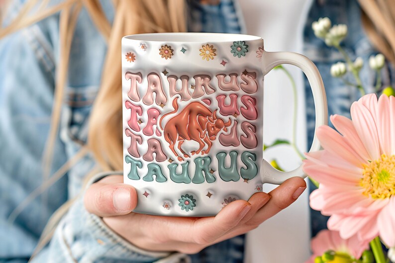 May include: White ceramic mug with a colourful retro design featuring the word "Taurus" repeated multiple times and a brown bull illustration in the centre.