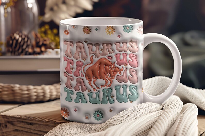 May include: White ceramic mug with a colourful design featuring the word "Taurus" repeated multiple times and a brown bull illustration. The mug has a white handle.