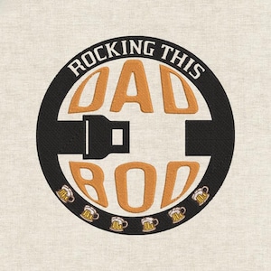 May include: Embroidered patch featuring the text "ROCKING THIS DAD BOD" in orange, within a black circle. The design includes a seatbelt graphic and beer mugs. The patch is on a beige fabric background.