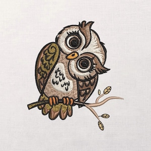 May include: Embroidered owl design in shades of brown, tan, and olive green, perched on a branch. The owl has large, expressive eyes and intricate feather detailing. The artwork is set against a white background.