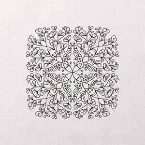 May include: Square, off-white fabric with a black floral embroidery design. The embroidery features a symmetrical pattern of stylized leaves, flowers, and berries, creating a delicate, nature-inspired motif. The design is centered on the fabric.
