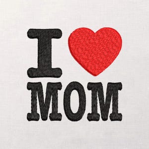 May include: Embroidered design on white fabric. The design features the words "I LOVE MOM" in black, with a red heart replacing the word "LOVE". The letters and heart are stitched with a textured effect.