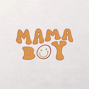 May include: Embroidered design on a white background. The text "MAMA BOY" is in a retro, bubble-style font, with a smiling face replacing the "O" in "BOY". The letters are a warm orange colour.