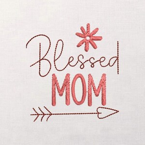 May include: Embroidered design on a white background. The text "Blessed MOM" is in a script font, with a flower and arrow accent. The embroidery is in shades of red and brown.
