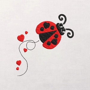 May include: Embroidered design of a red ladybug with black spots and a black head, featuring heart-shaped accents. The ladybug is accompanied by a curved line with red heart details, all set against a white background.
