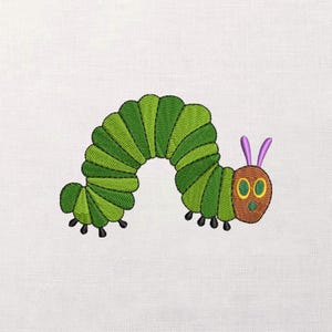 May include: Embroidered design of a green and yellow caterpillar with a brown head, purple antennae, and black feet. The caterpillar is on a white background. The design is likely for a children's item.