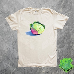 May include: A white t-shirt with a green and pink cabbage illustration printed on the front.