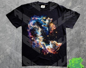 May include: Black t-shirt with a colorful galaxy print featuring three cats. The cats are in different poses, with one cat floating in the center of the galaxy.
