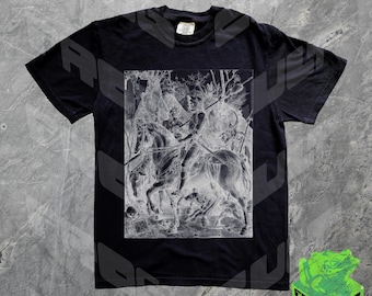 May include: Black t-shirt featuring a white graphic print of a knight on horseback riding through a forest. The graphic is a vintage style illustration.