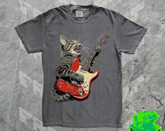 May include: A dark gray t-shirt with a graphic of a cat playing a red electric guitar.