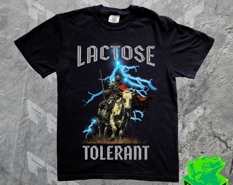 May include: Black t-shirt with a graphic of a knight riding a white horse with lightning bolts. The text "Lactose Tolerant" is printed on the shirt.