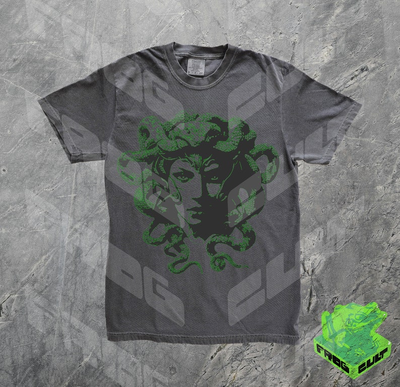 May include: A dark grey t-shirt with a green print of Medusa's head with snakes for hair.