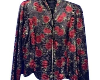 May include: A black velvet jacket with a red floral pattern. The jacket has a mandarin collar, long sleeves, and a button-down front. The floral design features red roses and green leaves.