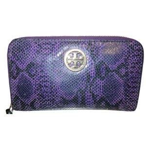 May include: A purple and black snakeskin-patterned wallet with a silver-colored zipper and a silver logo emblem. The wallet is rectangular and has a zip-around closure.