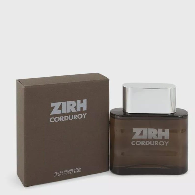 May include: A brown rectangular box and a brown perfume bottle with a silver cap. The box and bottle both have the text "ZIRH CORDUROY" printed on them. The bottle is labeled "EAU DE TOILETTE SPRAY 75 ml 2.5 US FL OZ."