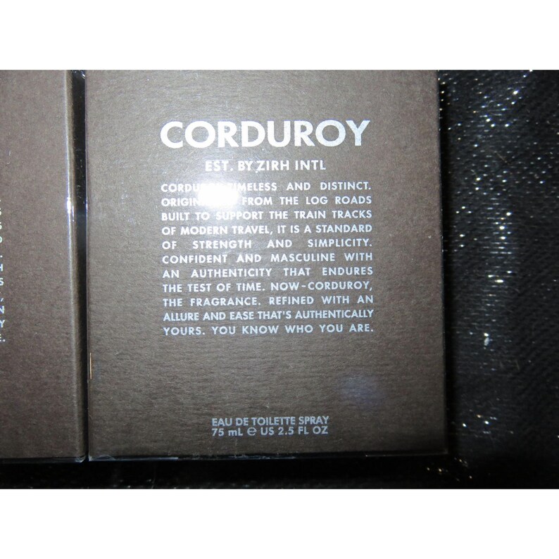 May include: A perfume box with the word "CORDUROY" in white lettering. The box also includes the text "EAU DE TOILETTE SPRAY 75 ml e US 2.5 fl oz". The box is a dark brown colour.