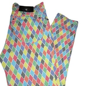 May include: Colorful, patterned pants with a repeating diamond design in various colors including red, yellow, blue, green, and black. The pants have a black label on the back.