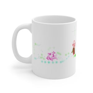 May include: White ceramic mug with a whimsical illustration. The design features a pink pig, a small figure, and green and blue accents. The mug has a curved handle and a glossy finish.
