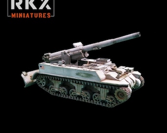 May include: A miniature model of a self-propelled artillery vehicle with a long barrel, painted in a weathered white and green camouflage pattern. The side features a small American flag decal. The text RKX MINIATURES is visible in the top corner.