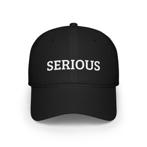 Peut inclure: Une casquette de baseball noire avec le mot "SERIOUS" brodé en blanc sur le devant.