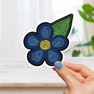 May include: A blue flower with a yellow centre and a green leaf. The flower is made of small circles and is a sticker.