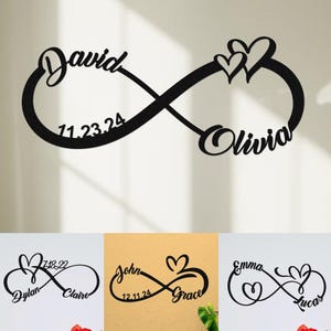 Puede incluir: Signo de infinito de metal negro con los nombres "David" y "Olivia" en escritura cursiva, junto con la fecha "11.23.24". Dos corazones están encima del nombre "Olivia". Se muestran signos de infinito adicionales con nombres y fechas debajo.