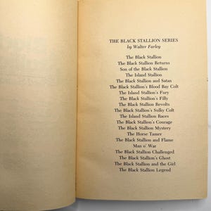 May include: Open book pages with text listing titles from "The Black Stallion Series" by Walter Farley. The titles are printed in black font on a cream-colored paper. The book is open to the title page.