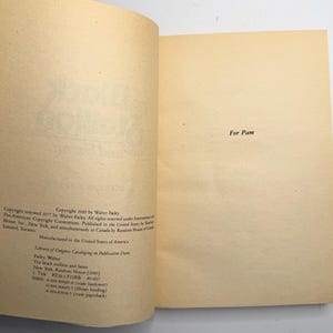 May include: Open book with aged, cream-colored pages. The text "For Pam" is centered on the right page. The left page contains copyright information, including the author's name, the title, and the publisher.