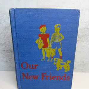 May include: A vintage book titled "Our New Friends" with a blue cover. The cover features illustrations of two children and a dog in yellow, with the title in red. The book is likely a children's story.