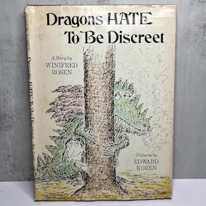 May include: Vintage book cover titled "Dragons HATE To Be Discreet" with illustrations of dragons and a tree. The cover is off-white with black text and drawings in green and brown. The author is Winifred Rosen, and the pictures are by Edward Koren.