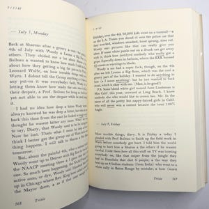 May include: An open book with handwritten diary entries. The pages are aged, with visible text and dates. The text contains references to events and personal reflections. The book is open to pages 168 and 169.