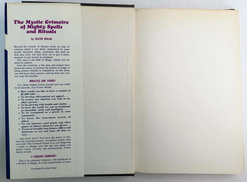 May include: Open book titled "The Mystic Grimoire of Mighty Spells and Rituals" by Frater Malak. The cover is dark blue with white text. The open pages are off-white with black text describing the book's contents.