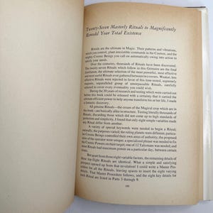 May include: Open book with text titled "Twenty-Seven Masterly Rituals to Magnificently Remodel Your Total Existence." The pages are off-white with black text. The book is open to a page with text.