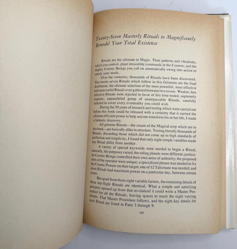 May include: Open book with text titled "Twenty-Seven Masterly Rituals to Magnificently Remodel Your Total Existence." The pages are off-white with black text. The book is open to a page with text.