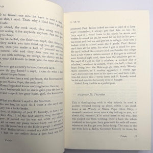 May include: An open book with text on the pages. The left page has a paragraph starting with "O to Russel one nite he have to write a check". The right page has text starting with "possessed. Prof. Boiloo looked me over & sayd ok & Lary sayd".
