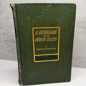 May include: A hardcover book titled A Renegade and Other Tales by Martha Wolfenstein. The book features a dark green cloth cover with a rectangular gold-bordered label on the front, containing the title and author name in gold lettering.