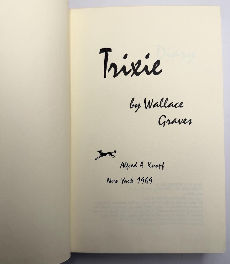 May include: An open book page displaying the title "Trixie" by Wallace Graves. The page includes the publisher's name, Alfred A. Knopf, and the year of publication, 1969, in black ink. A small illustration of a running dog is also present.