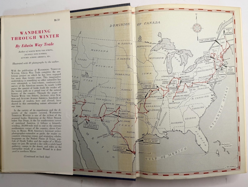 May include: An open book with the title "Wandering Through Winter" by Edwin Way Teale. The left page displays text, while the right page features a detailed map of the United States with a red route marked across it.