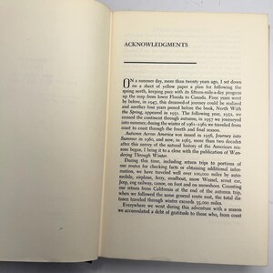 May include: Open book with text titled "ACKNOWLEDGMENTS." The text describes a journey across America, mentioning travel by various modes, including automobile, airplane, and canoe. The text also mentions the book "North With the Spring."