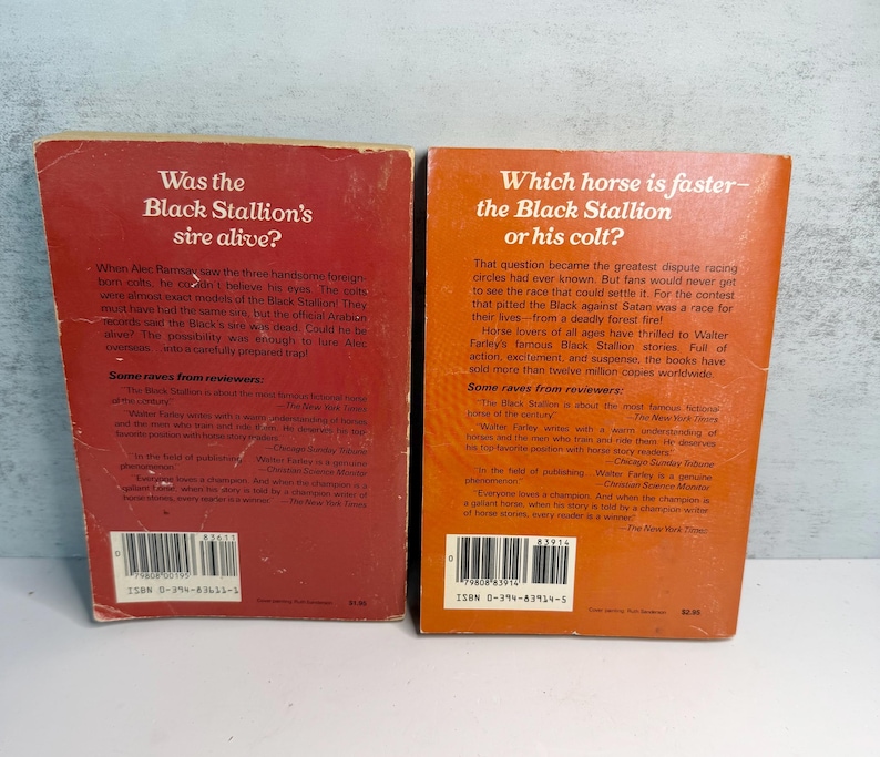 May include: Two vintage paperback books with the titles "Was the Black Stallion's sire alive?" and "Which horse is faster - the Black Stallion or his colt?" The books are in red and orange with white text.